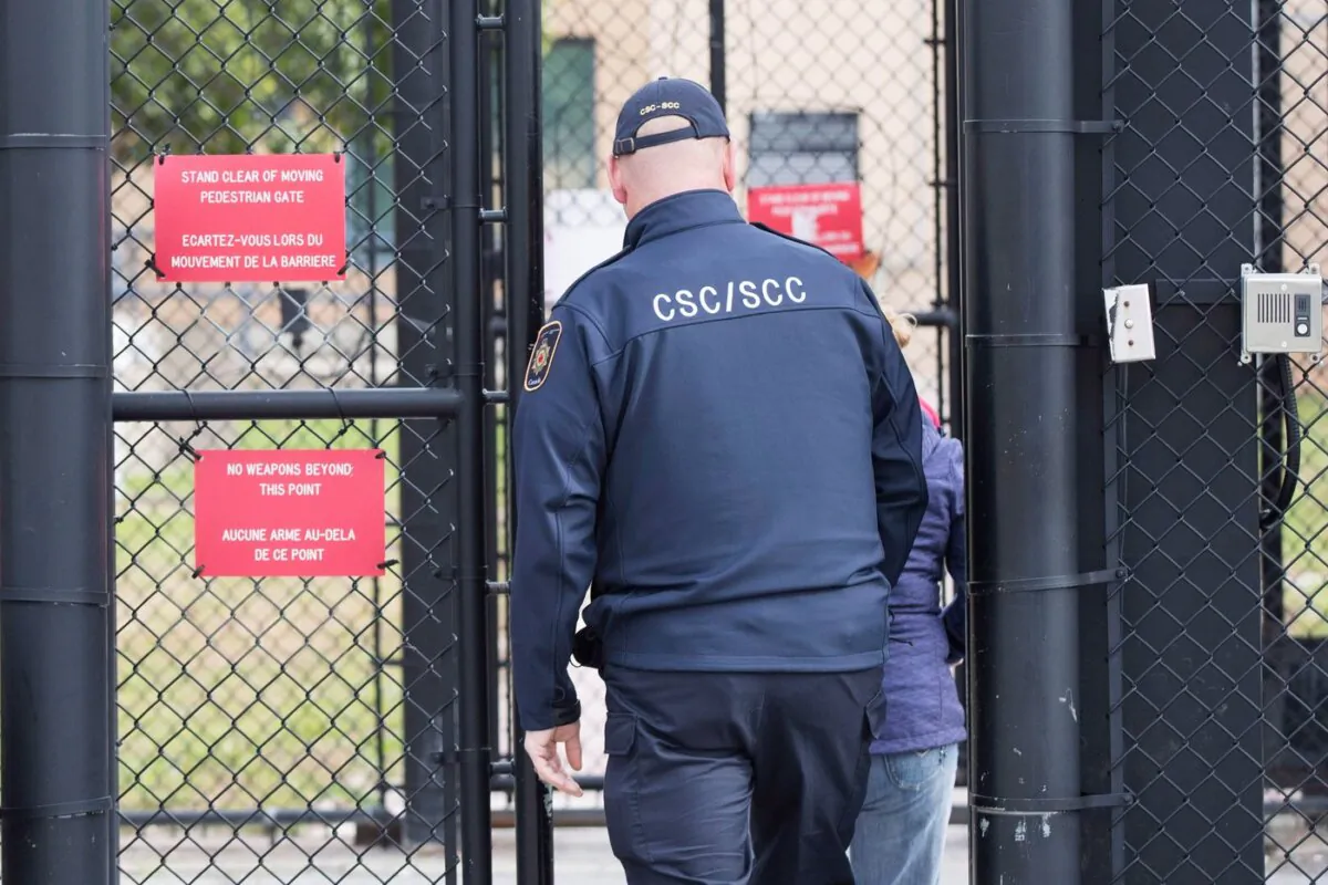 A correctional officer enters the gate at Millhaven Institution in Bath, Ontario, on Oct. 17, 2018. (The Canadian Press/Lars Hagberg)