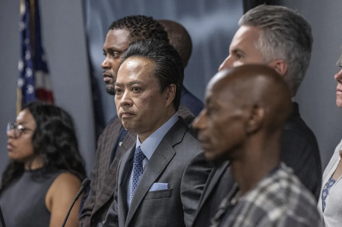 Sacramento County District Attorney Thien Ho (C) stands with supporters and victims of alleged crimes by homeless residents at a news conference announcing that his office is suing the City of Sacramento on Sept. 19, 2023. (Hector Amezcua/The Sacramento Bee via AP)