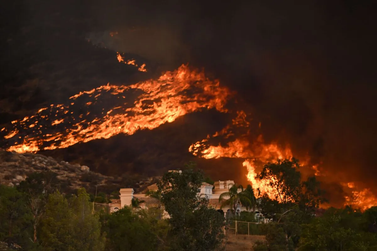 Plumes of smoke rise as wildfire approaches a home during the Fairview Fire near Hemet, Calif., on Sept. 7, 2022. (Patrick T. Fallon/AFP via Getty Images)