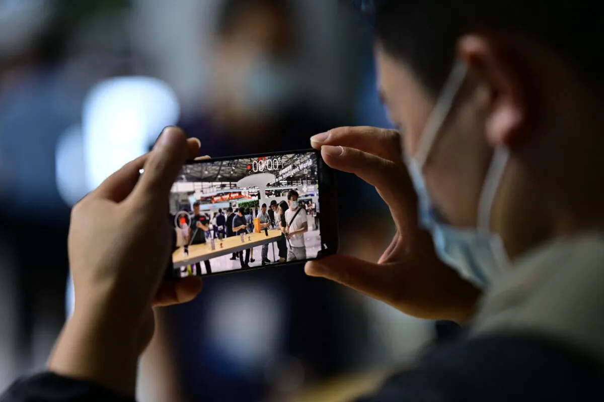 A man tests a Huawei smartphone at the Mobile World Congress (MWC) in Shanghai on June 28, 2023. (Pedro Pardo/AFP via Getty Images)
