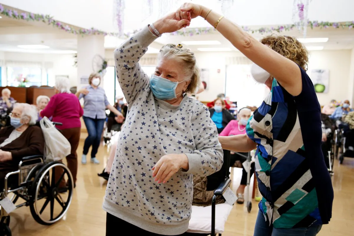 Residents and staff gather and dance during an Easter concert for vaccinated residents at the Ararat Nursing Facility in Los Angeles, Calif., on April 1, 2021. (Mario Tama/Getty Images)