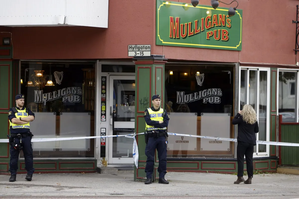 Police stand outside a pub where two people were killed and two wounded following a shooting in Sandviken, some 162 kilometers (100 miles) northwest of Stockholm, on Sept. 22, 2023. (Henrik Hansson/TT News Agency via AP)