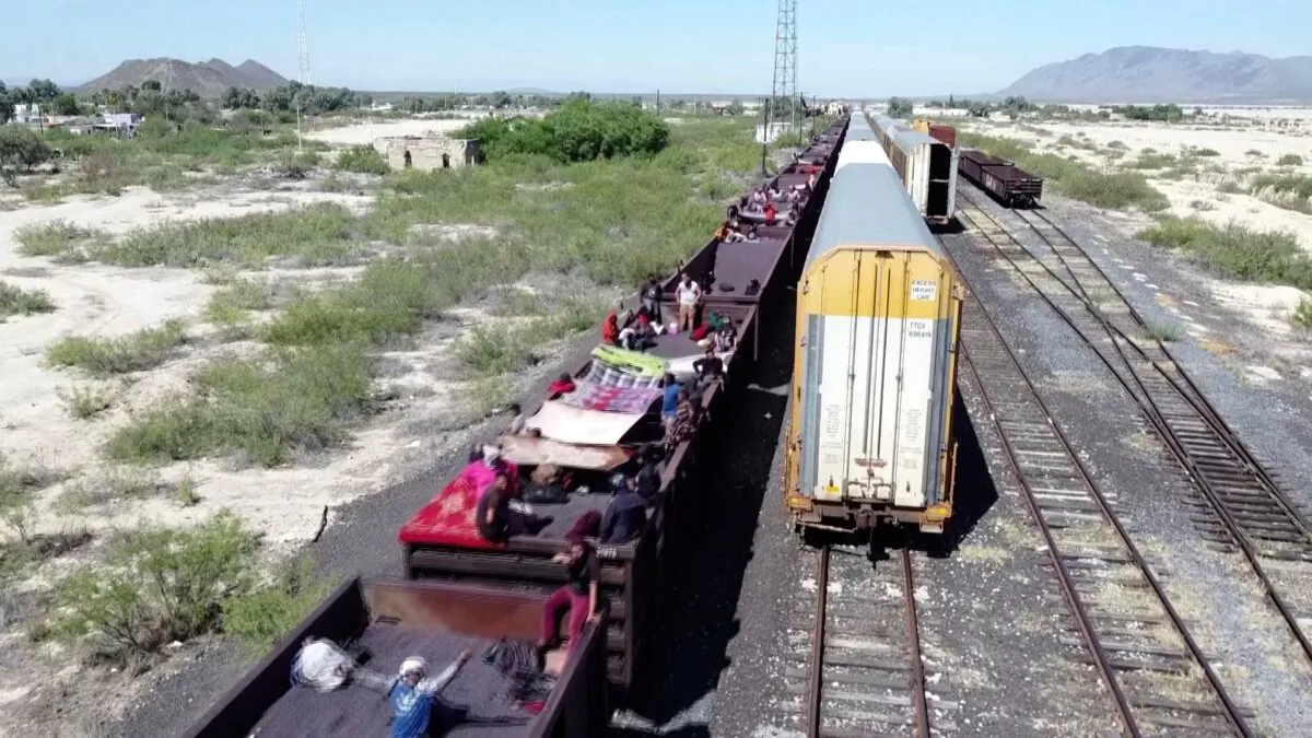 Illegal immigrants ride on top of a cargo train crossing northeast Mexico on Sept. 21, 2023. (Reuters/Screenshot via NTD)