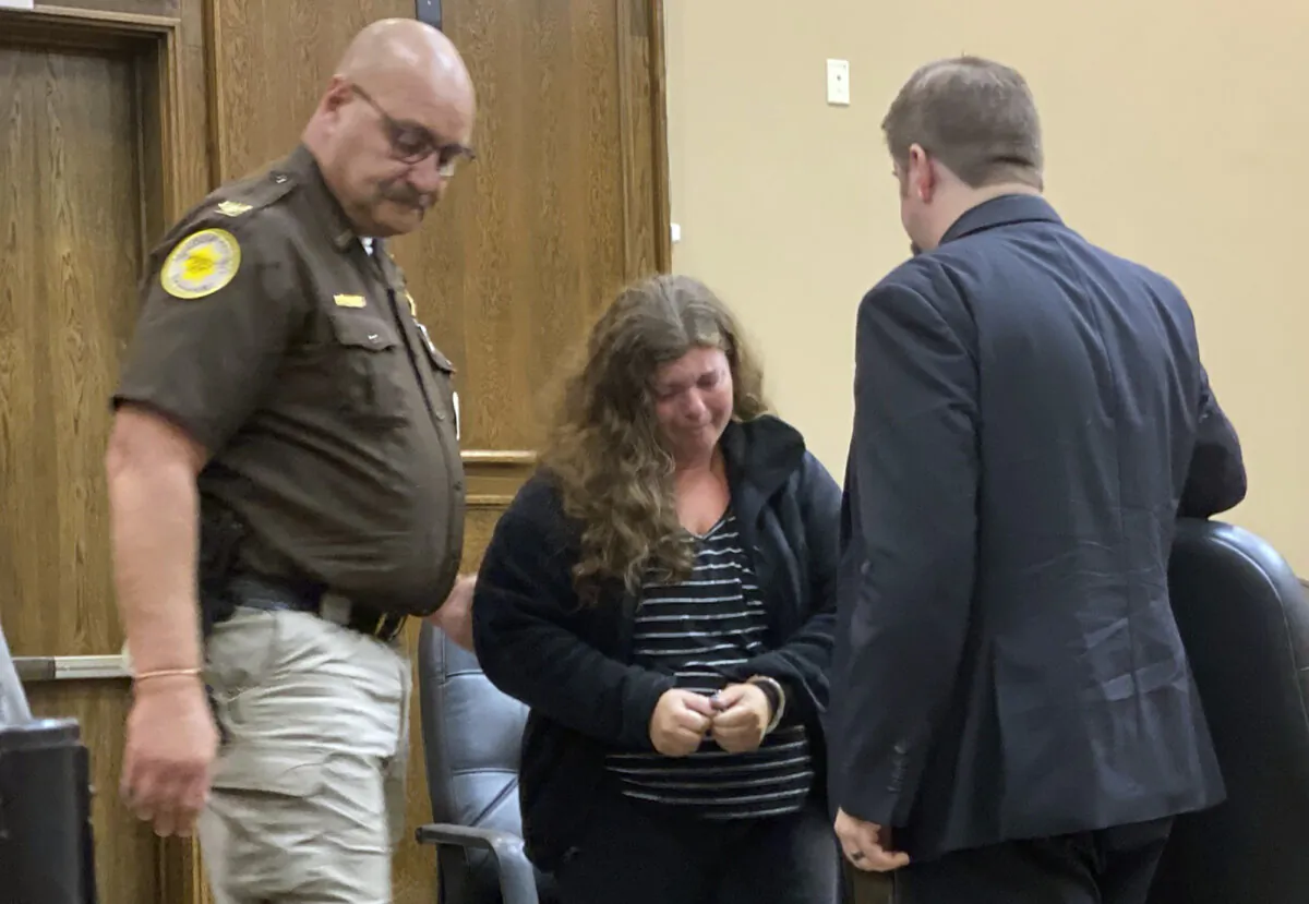 Jessica Burgess (C), alongside her attorney Brad Ewalt (R), is escorted out of the Madison County District courtroom by Madison County Sheriff Todd Volk, in Madison, Neb., on Sept. 22, 2023. (Austin Svehla/Norfolk Daily News via AP)