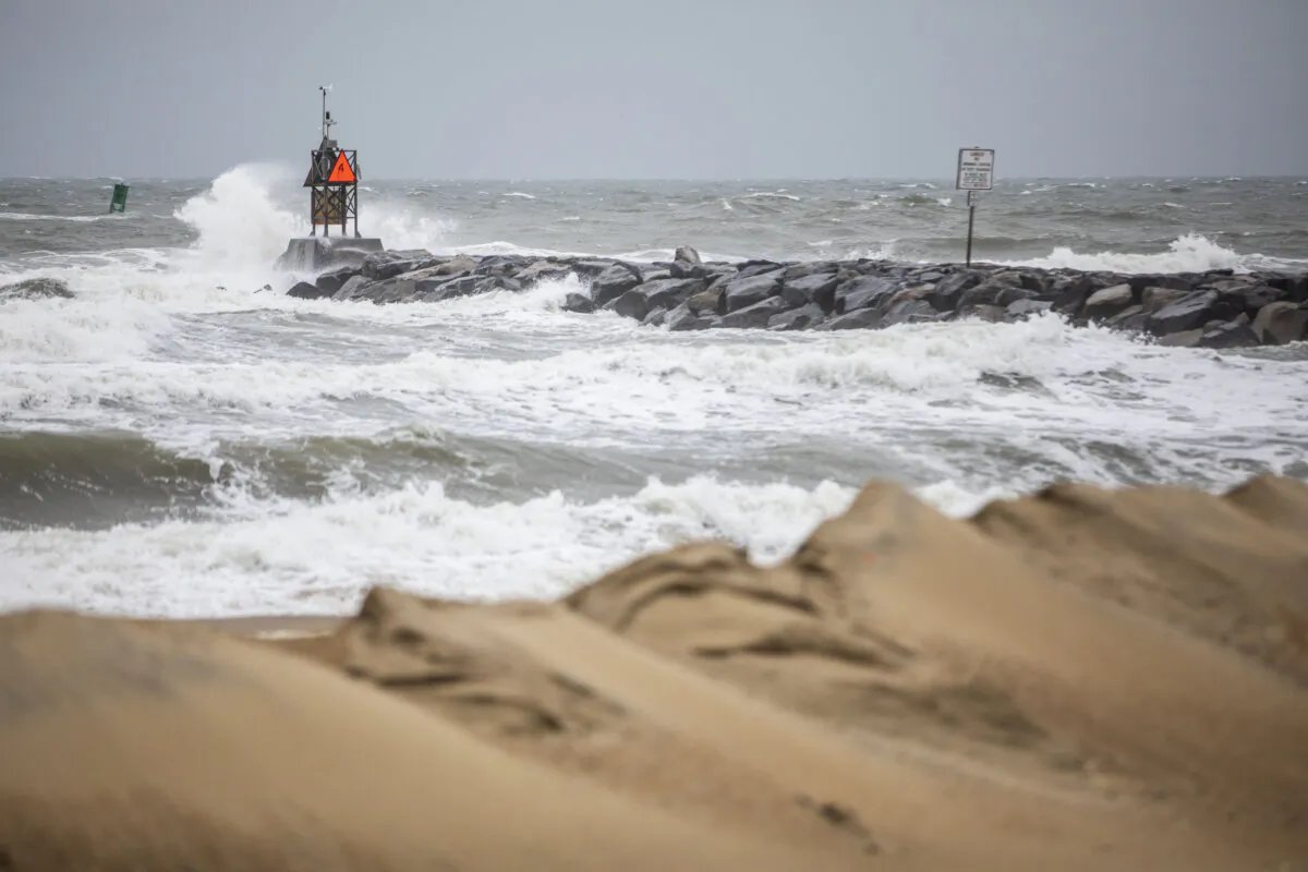 Waves break along the jetty at Rudee Inlet in Virginia Beach, Va., on Sept. 22, 2023, as Tropical Storm Ophelia approaches the area. (Kendall Warner/The Virginian-Pilot via AP)