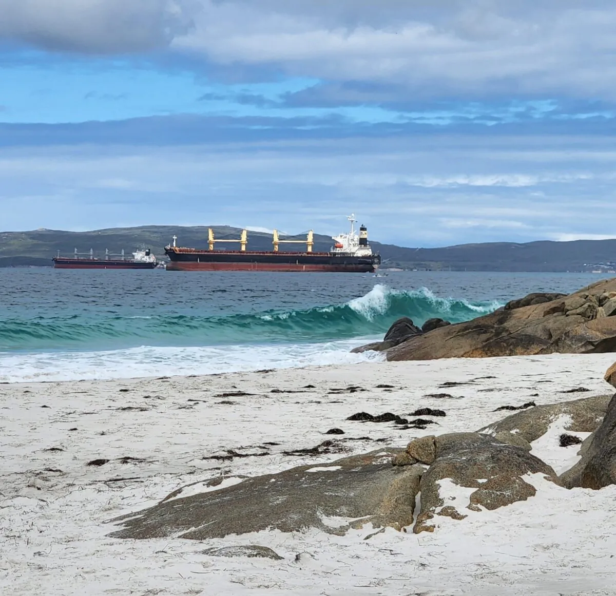 Two cargo ships can be seen waiting to dock and load off the coast of Albany, Western Australia on March 18, 2023. (Susan Mortimer/The Epoch Times)