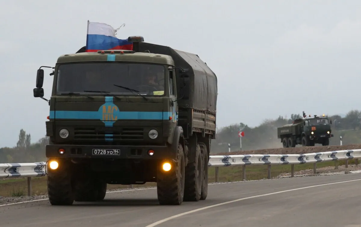 Russian peacekeepers drive trucks in direction towards the Armenia-Azerbaijan border and Nagorno Karabakh region near the village of Kornidzor, Armenia, on Sept. 23, 2023. (Irakli Gedenidze/Reuters)