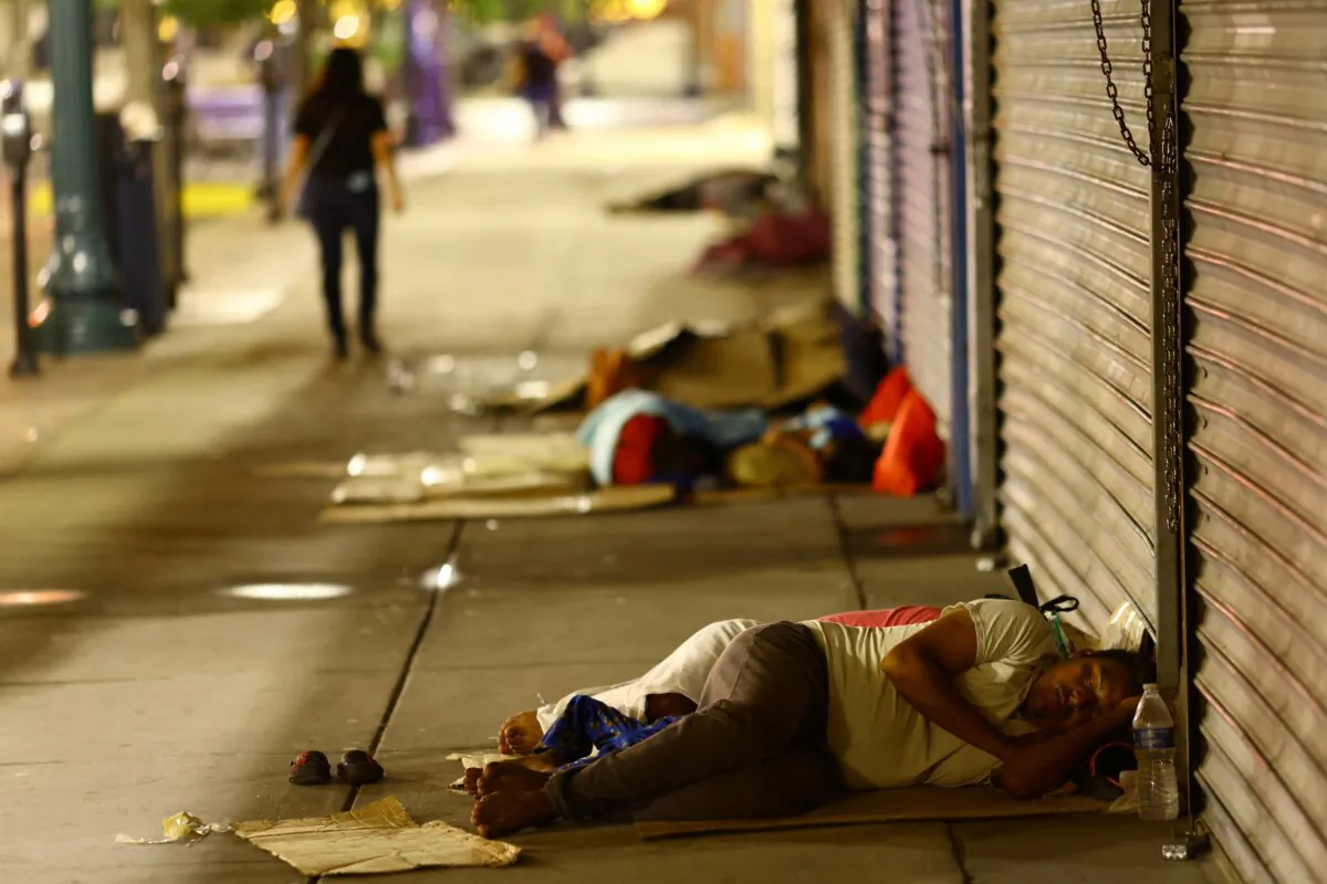 Migrants sleep on the street after being released from U.S. Border Patrol custody in downtown El Paso, Texas, on Sept. 12, 2023. (Jose Luis Gonzalez/Reuters)