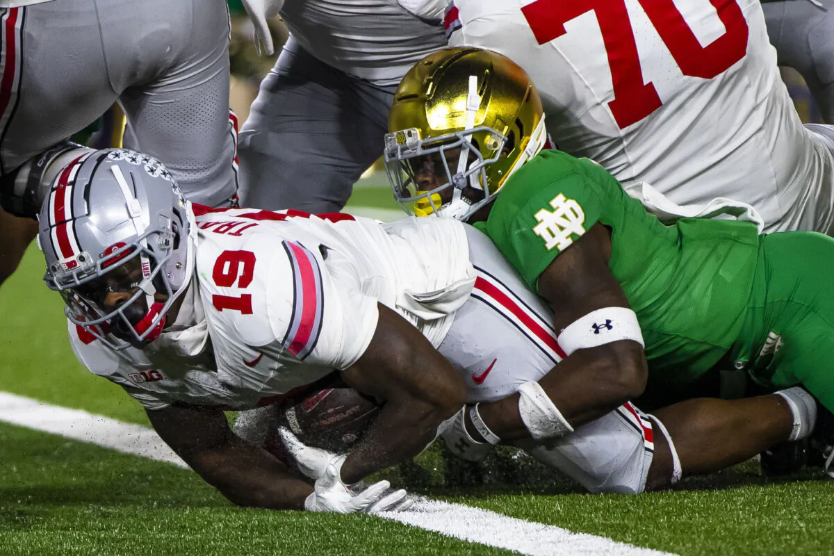 Ohio State running back Chip Trayanum (19) scores as Notre Dame safety DJ Brown (2) tries to stop him during the second half of an NCAA college football game in South Bend, Ind., on Sept. 23, 2023. (Michael Caterina/AP Photo)