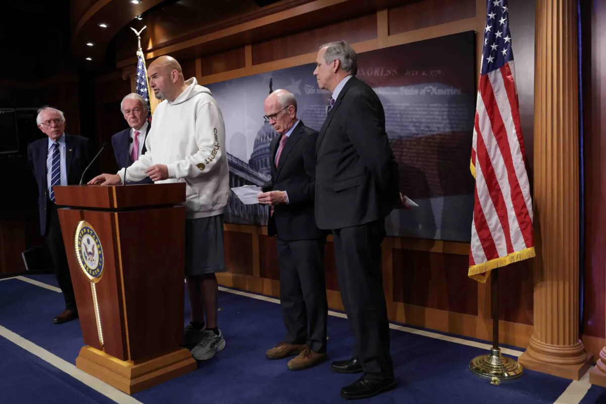 From left, Sens. Bernie Sanders of Vermont (an independent who caucuses with Democrats), Ed Markey (D-Mass.), Peter Welch (D-Vt.), and Jeff Merkley (D-Ore.) listen as Sen. John Fetterman (D-Pa.) speaks at a news conference at the Capitol in Washington on May 18, 2023. (Alex Wong/Getty Images)
