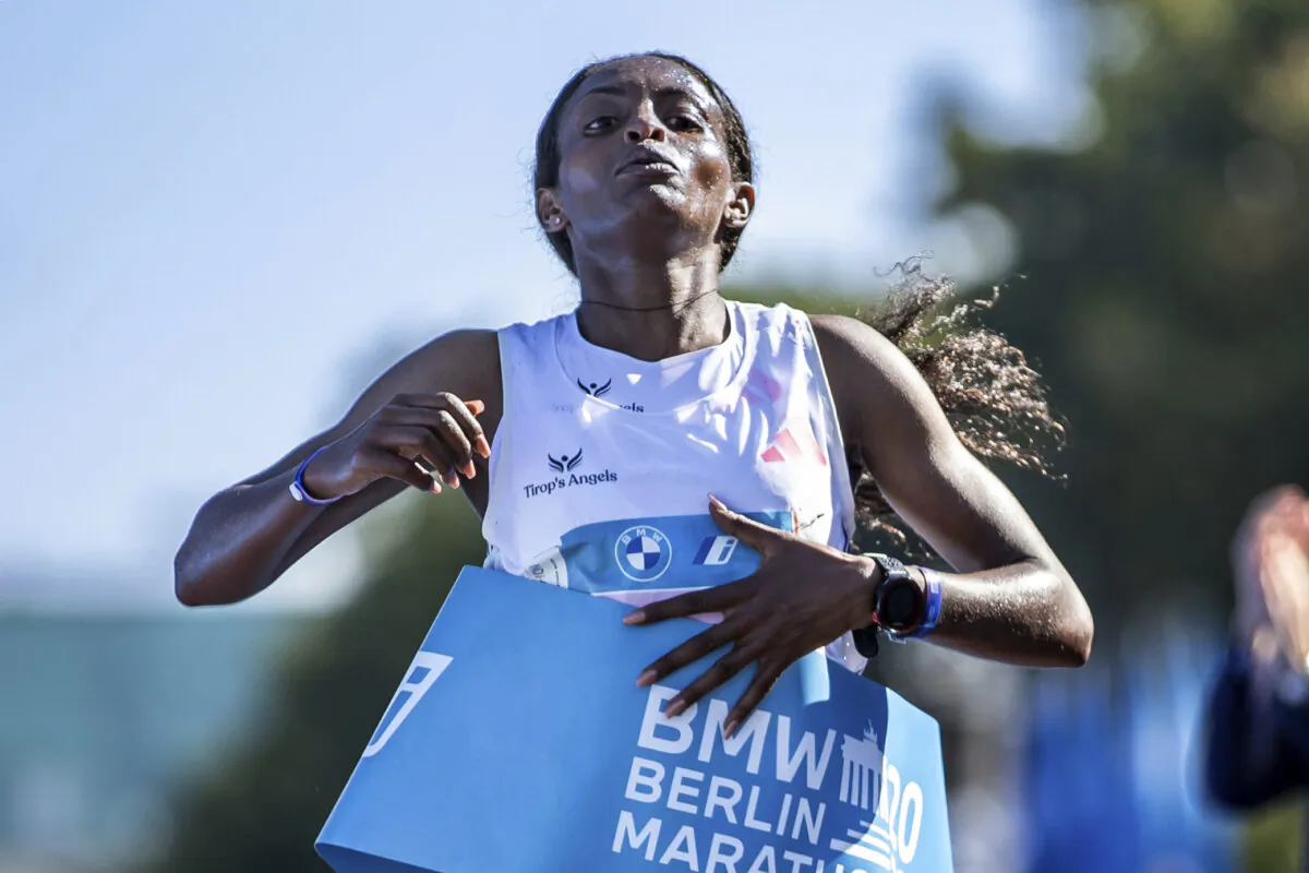 Ethiopia's Tigst Assefa crosses the finish line as the first woman to finish the Berlin Marathon in Berlin on Sept. 24, 2023. (Andreas Gora/dpa via AP)