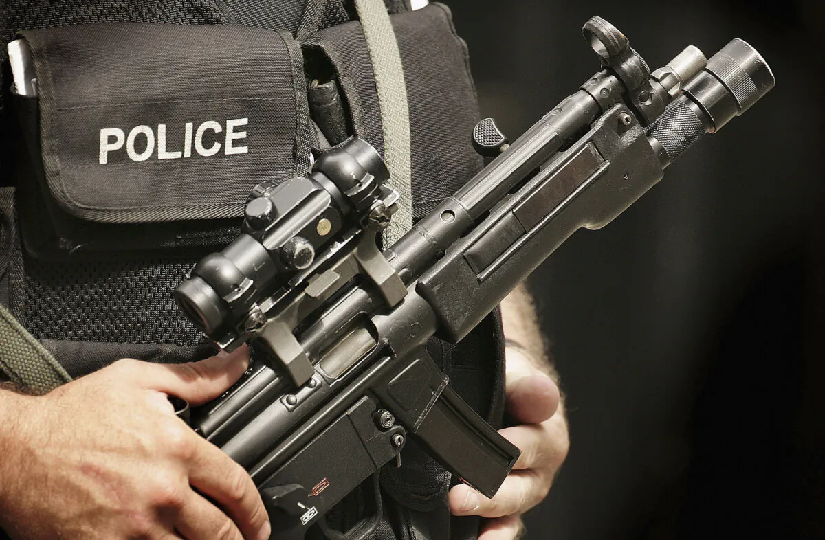 An armed police officer stands in Downing Street, London, on July 26, 2005. (Peter MacDiarmid/Getty Images)