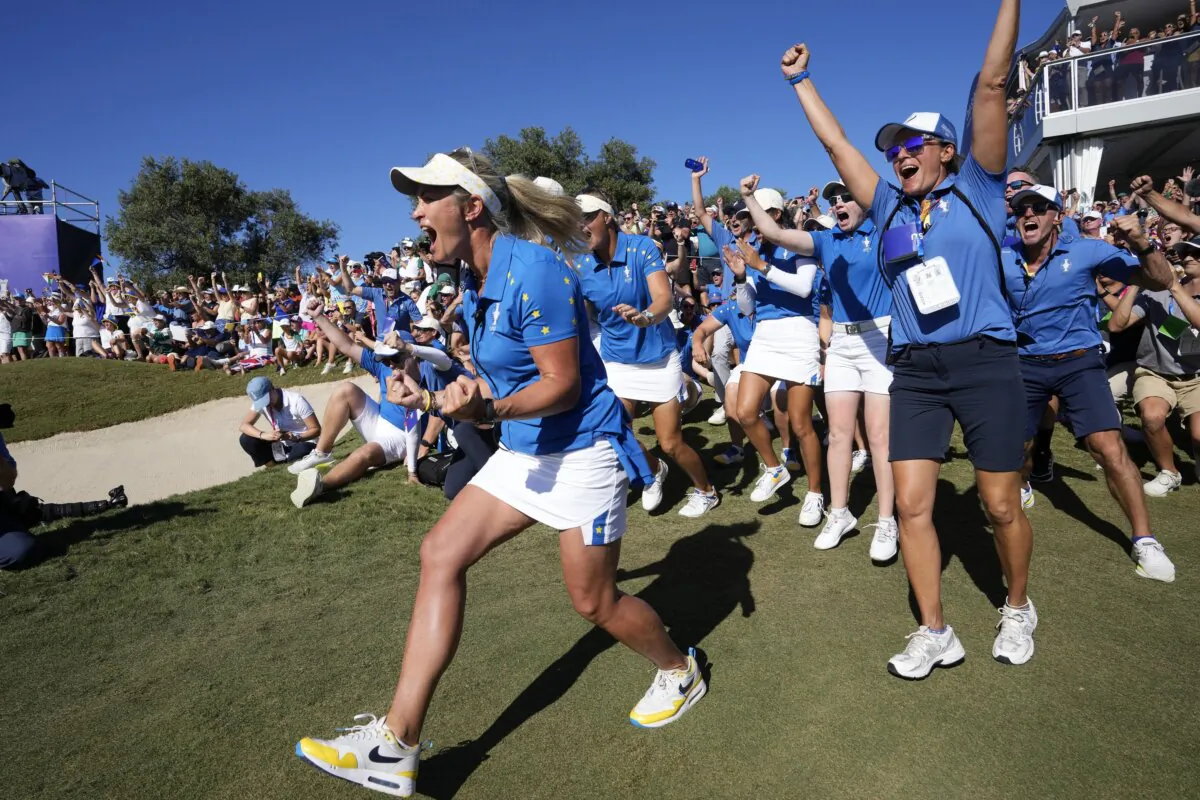 Members of the Europe team and supporters celebrate at the end of the match between Europe's Carlota Ciganda and United States' Nelly Korda at the Solheim Cup golf tournament in Finca Cortesin, near Casares, southern Spain, on Sept. 24, 2023. (Bernat Armangue/AP Photo)
