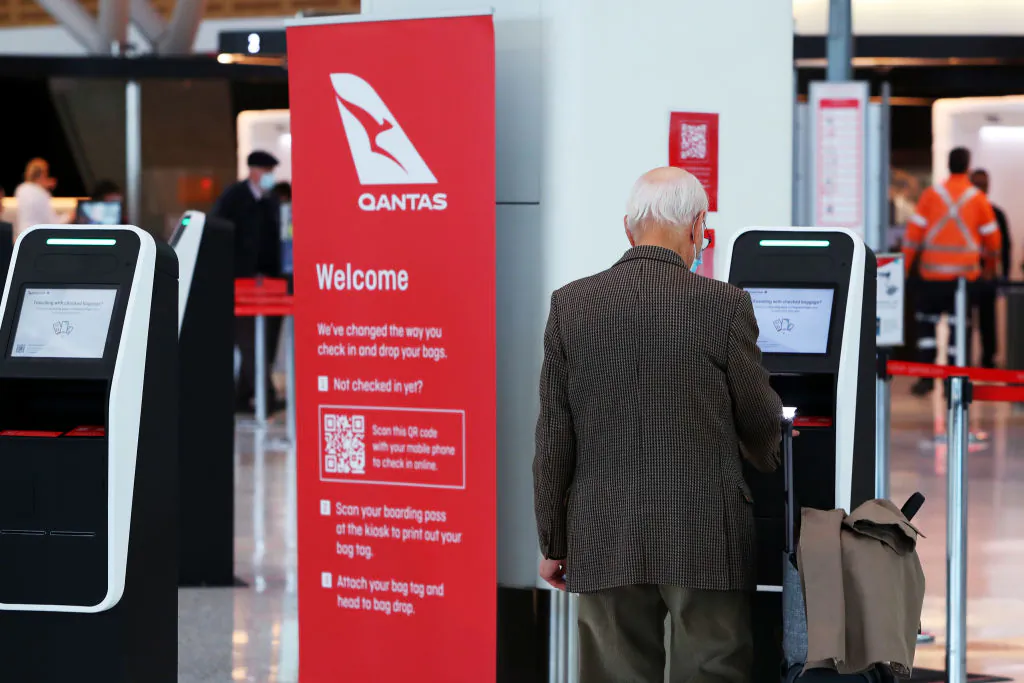 A man checks in on arrival at the Qantas domestic terminal at Sydney Airport in Australia on Aug. 25, 2022 in Sydney. (Lisa Maree Williams/Getty Images)
