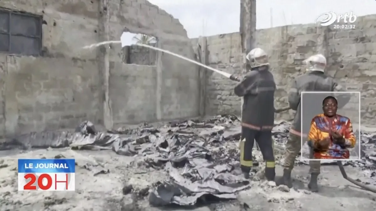 Firefighters spray water at the scene of a fire in Seme-Podji, Benin, on Sept. 23, 2023, in a still from video. (ORTB via AP/Screenshot via The Epoch Times)