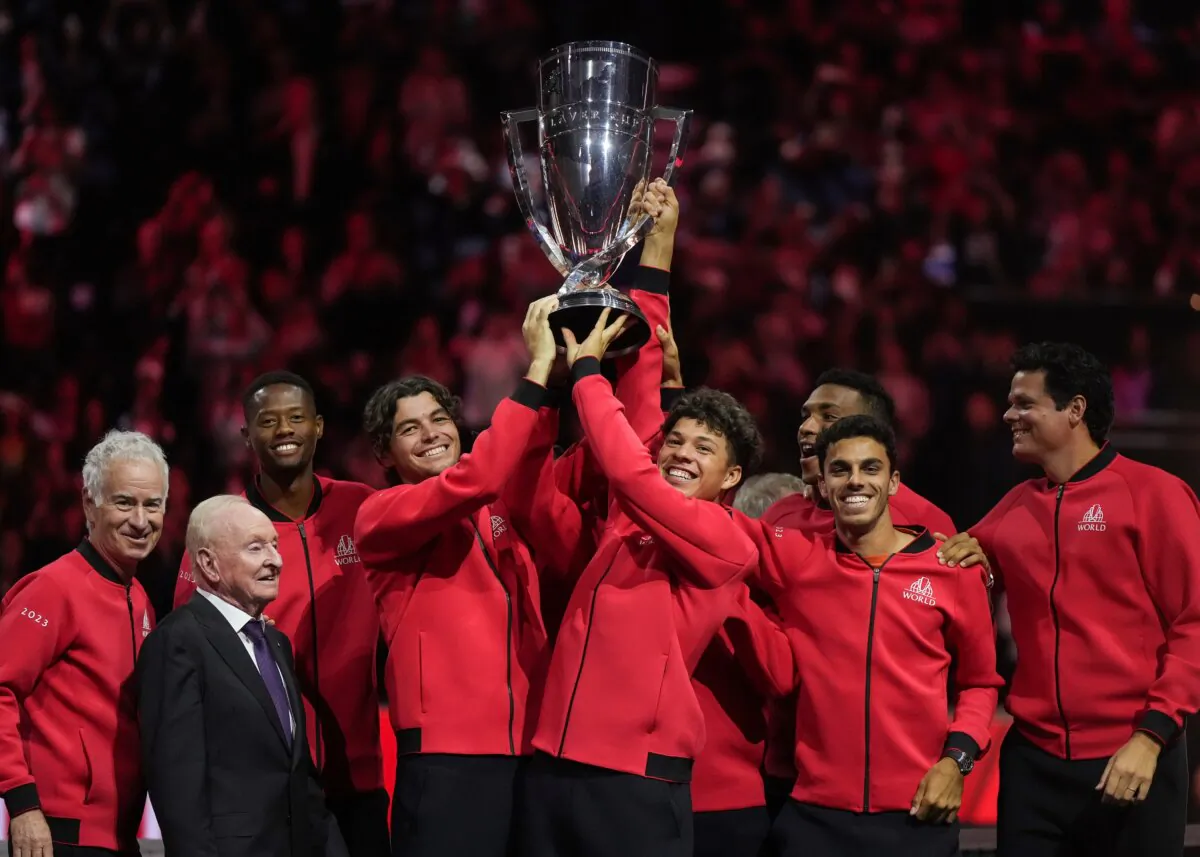 Team World's Taylor Fritz (4th L), and Ben Shelton (5th L), hoist the Laver Cup in front of teammates, John McEnroe (L), and Rod Laver (2nd L) after Team World defeated Team Europe at the Laver Cup tennis tournament in Vancouver, British Columbia, Canada, on Sept. 24, 2023. (Darryl Dyck/The Canadian Press via AP)