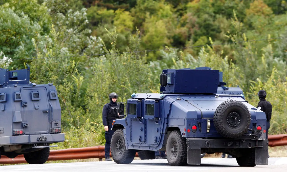 Kosovo police officers patrol a road to Banjska Monastery, in the aftermath of a shooting incident, near Zvecan, Kosovo, on Sept. 25, 2023. (Ognen Teofilovski/Reuters)