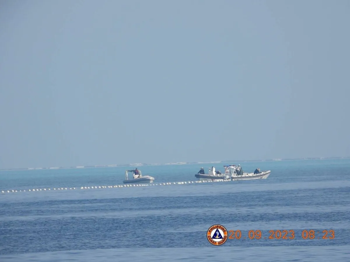 Chinese Coast Guard boats close to the floating barrier near the Scarborough Shoal in the South China Sea, on Sept. 20, 2023. (Philippine Coast Guard/Handout via Reuters)