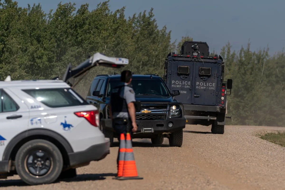 A tactical armoured RCMP vehicle drives past a police roadblock set up at James Smith Cree Nation, Sask., on Sept. 6, 2022. (The Canadian Press/Heywood Yu)