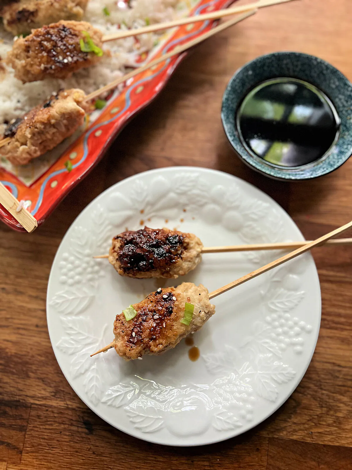 Chicken skewers with a salty-sweet yakitori sauce are simmered in water before being glazed on the grill. (Gretchen McKay/Pittsburgh Post-Gazette/TNS)