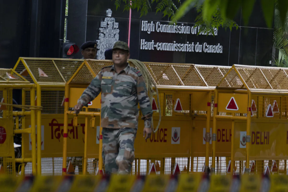 An Indian paramilitary soldier stands guard next to a police barricade outside the Canadian High Commission in New Delhi, India, on Sept. 19, 2023. Tensions between India and Canada are high after Prime Minister Justin Trudeau's government expelled a top Indian diplomat and accused India of having links to the assassination in Canada of Sikh leader Hardeep Singh Nijjar, a strong supporter of an independent Sikh homeland. (AP Photo/Altaf Qadri)