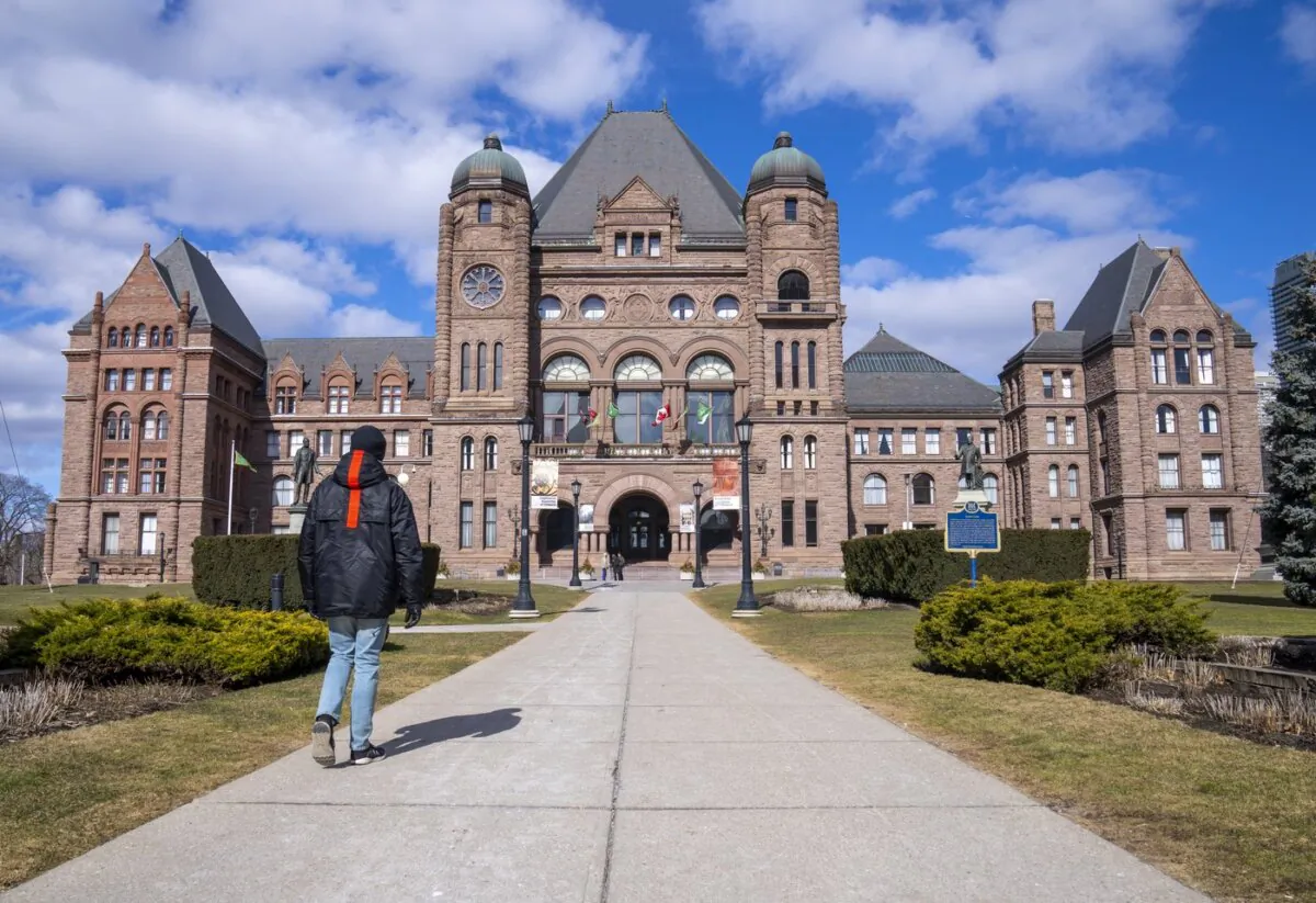 A man walks in front of Queen’s Park in Toronto, on Feb. 20, 2023. (The Canadian Press/Frank Gunn)