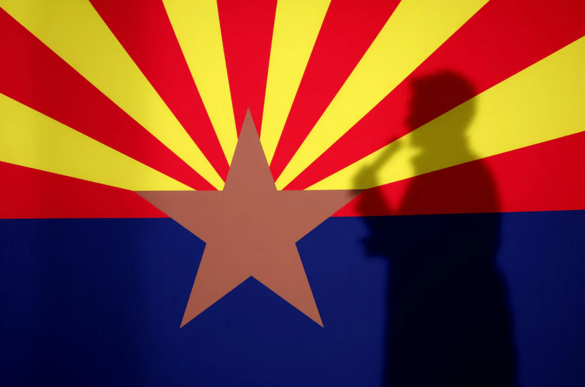 The shadow of then-Arizona Republican gubernatorial candidate Kari Lake is cast onto the Arizona state flag as she speaks during a get-out-the-vote campaign rally in Prescott, Ariz., on Nov. 7, 2022. (Justin Sullivan/Getty Images)