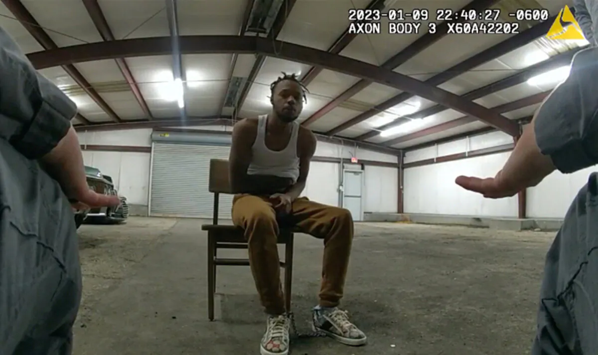 In this image from Baton Rouge Police Department body camera video, officers interact with Jeremy Lee inside a warehouse in Baton Rouge on Jan. 9, 2023. (Baton Rouge Police Department via AP)