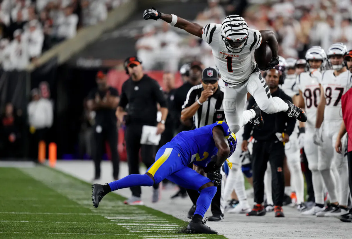 Ja'Marr Chase (1) of the Cincinnati Bengals jumps over Russ Yeast (2) of the Los Angeles Rams during the fourth quarter in the game at Paycor Stadium in Cincinnati on Sept. 25, 2023. (Dylan Buell/Getty Images)