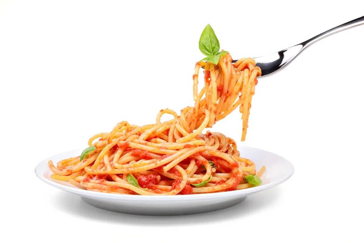 Spaghetti with tomato and basil on white background. (picturepixx/Shutterstock)