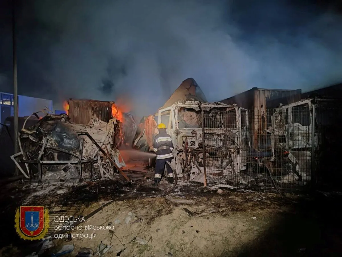 Firefighters work near damaged trucks following a Russian strike at a location given as Odesa region, Ukraine, on Sept. 26, 2023. (Odesa Regional Military Administration/Handout via Reuters)
