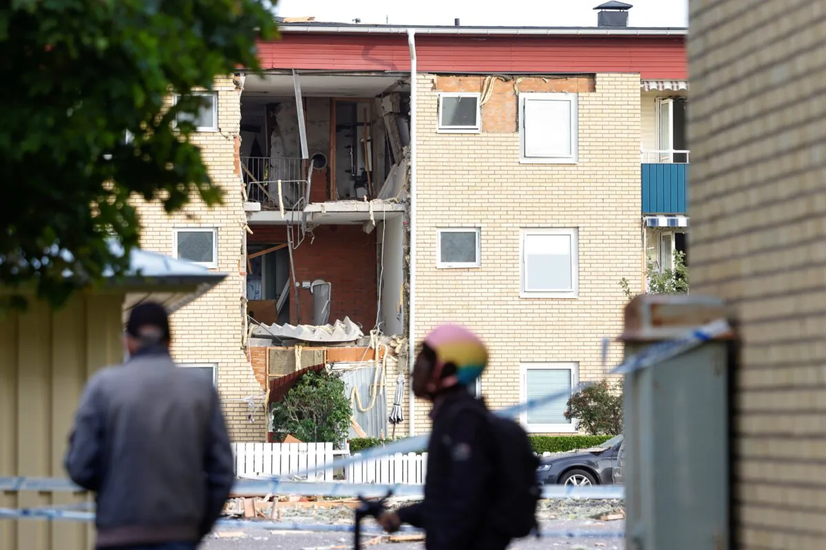 People look at the damages caused by an explosion in a residential building in the Ekholmen area, in Linköping, Sweden, on Sept. 26, 2023. (Stefan Jerrevång/TT News Agency via AP)