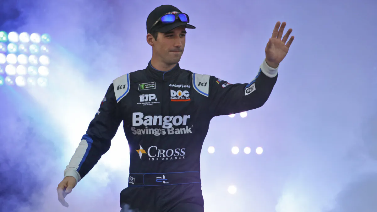 Austin Theriault greets fans during driver introductions for the NASCAR Monster Energy Cup series auto race at Richmond Raceway in Richmond, Va., on Sept. 21, 2019. (Steve Helber/AP Photo)