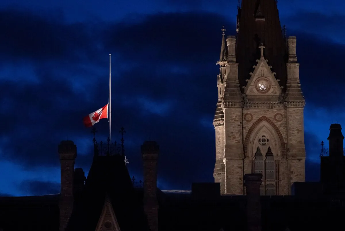 The Canadian flag flies at half-mast over the Parliament Buildings during a ceremony on Parliament Hill on the eve of the first National Day of Truth and Reconciliation on Sept. 29, 2021. (The Canadian Press/Adrian Wyld)