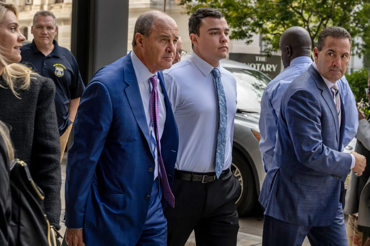 Philadelphia police Officer Mark Dial (C) arrives at the Juanita Kidd Stout Center for Criminal Justice in Philadelphia on Sept. 19, 2023, with attorneys Brian McMonagle (L) and Fortunato Perri (R) for a bail hearing. (Tom Gralish/The Philadelphia Inquirer via AP)