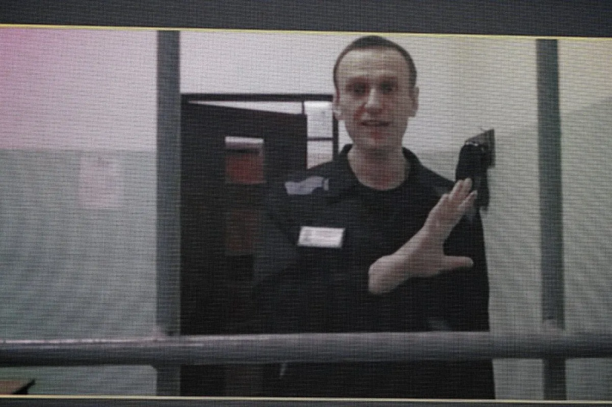 Russian opposition leader Alexei Navalny is seen on a TV screen as he appears in a video link provided by the Russian Federal Penitentiary Service from the colony in Melekhovo, Vladimir region, during a hearing at the Russian Supreme Court in Moscow on Aug. 23, 2023. (Alexander Zemlianichenko/AP Photo)