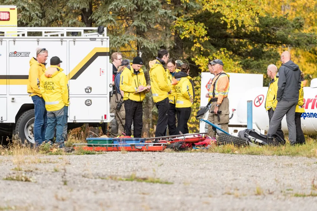 Prince George Search and Rescue crews prepare their gear in a staging area at Purden Lake Resort near the site of a helicopter crash, east of Prince George, B.C., on Sept. 26, 2023. (The Canadian Press/James Doyle)