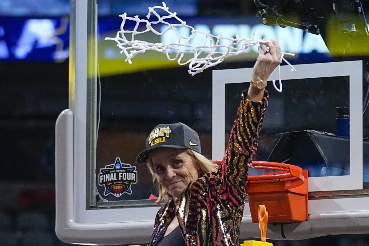 LSU head coach Kim Mulkey celebrates after cutting down the net after the NCAA Women's Final Four championship basketball game against Iowa in Dallas on April 2, 2023. (Tony Gutierrez/AP Photo)