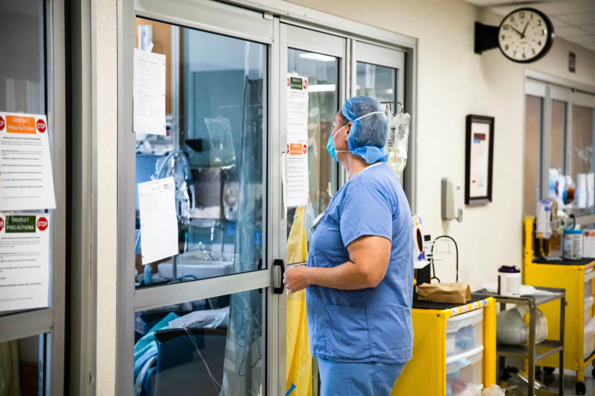 A health care professional in a hospital prepares to enter a patient's room. (File, Megan Jelinger/AFP via Getty Images)