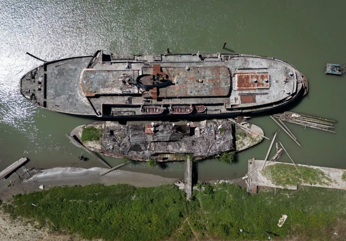 The retired BC Ferries vessel Queen of Sidney, top, that was in operation from 1960 to 2000, and another derelict vessel are seen moored on the Fraser River, in Mission, B.C., on July 18, 2023. (The Canadian Press/Darryl Dyck)