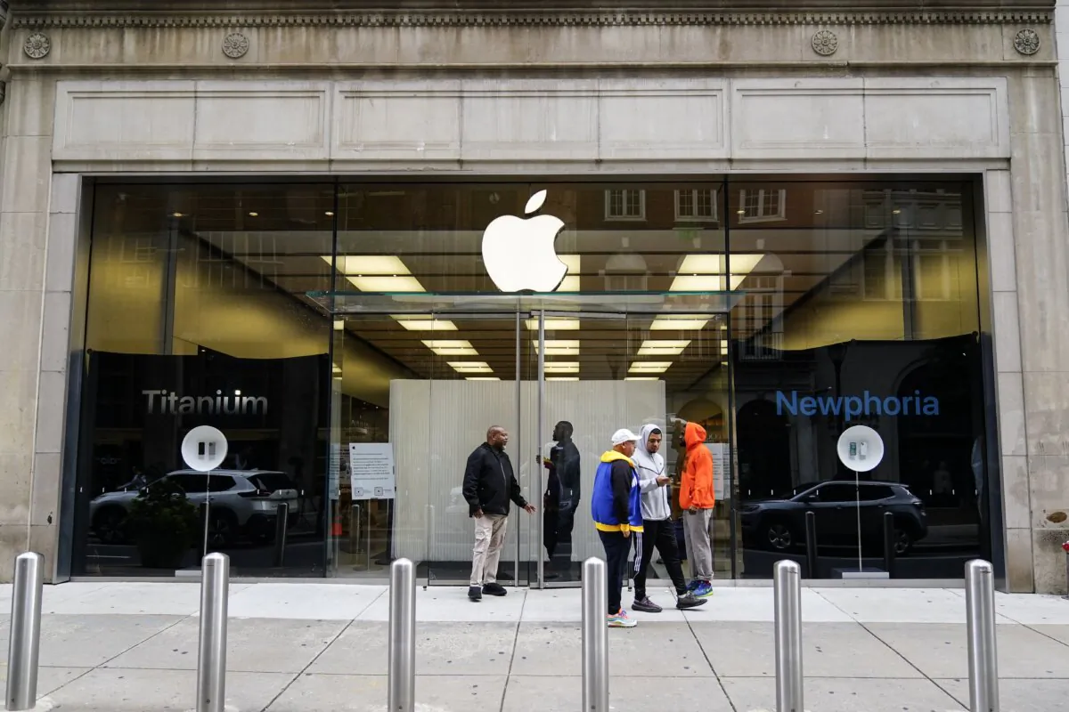 People stand outside an Apple Store in Philadelphia on Sept. 27, 2023, after it was ransacked the previous evening. (Matt Rourke/AP Photo)