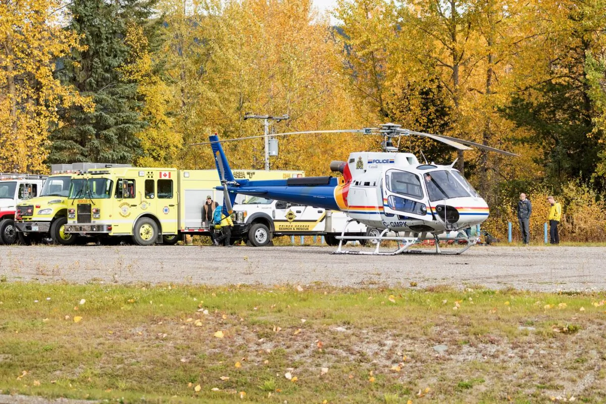 A police helicopter prepares for takeoff from a staging area at Purden Lake Resort near the site of the crash on Sept. 26, 2023. (The Canadian Press/James Doyle)
