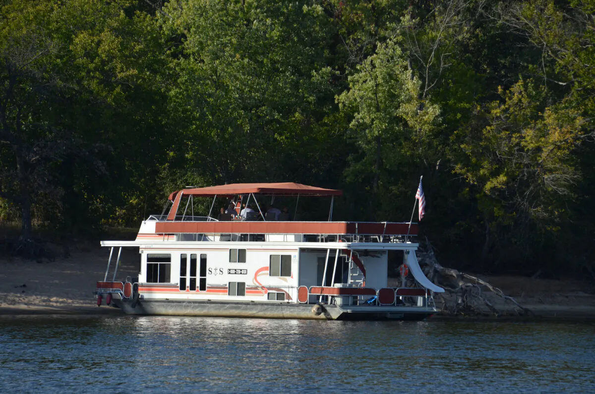 A houseboat rental run up on a sandy island in preparation for a beach picnic. (Kevin Revolinski)