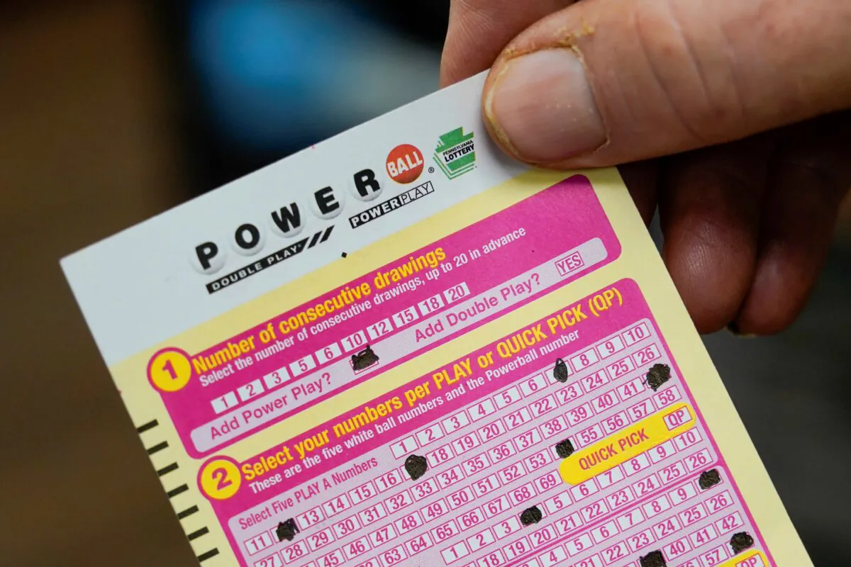 A person shows his scan card for their personal selection numbers for a ticket for a Powerball drawing in Renfrew, Pa., on Nov. 7, 2022. (Keith Srakocic/AP Photo)