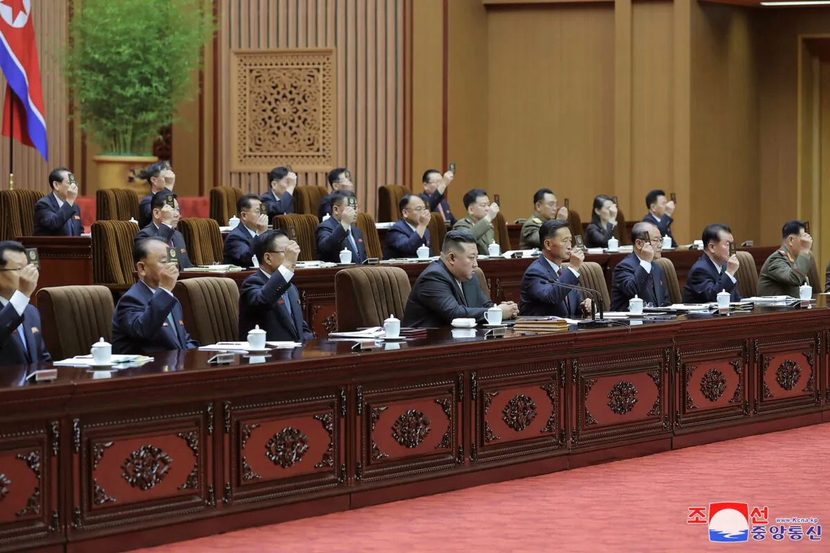 North Korean leader Kim Jong Un, (bottom C), attends a meeting of the country's parliament in Pyongyang, North Korea, in this photo provided by the North Korean government and taken during a two-day session on Sept. 26–27, 2023. (Korean Central News Agency/Korea News Service via AP)