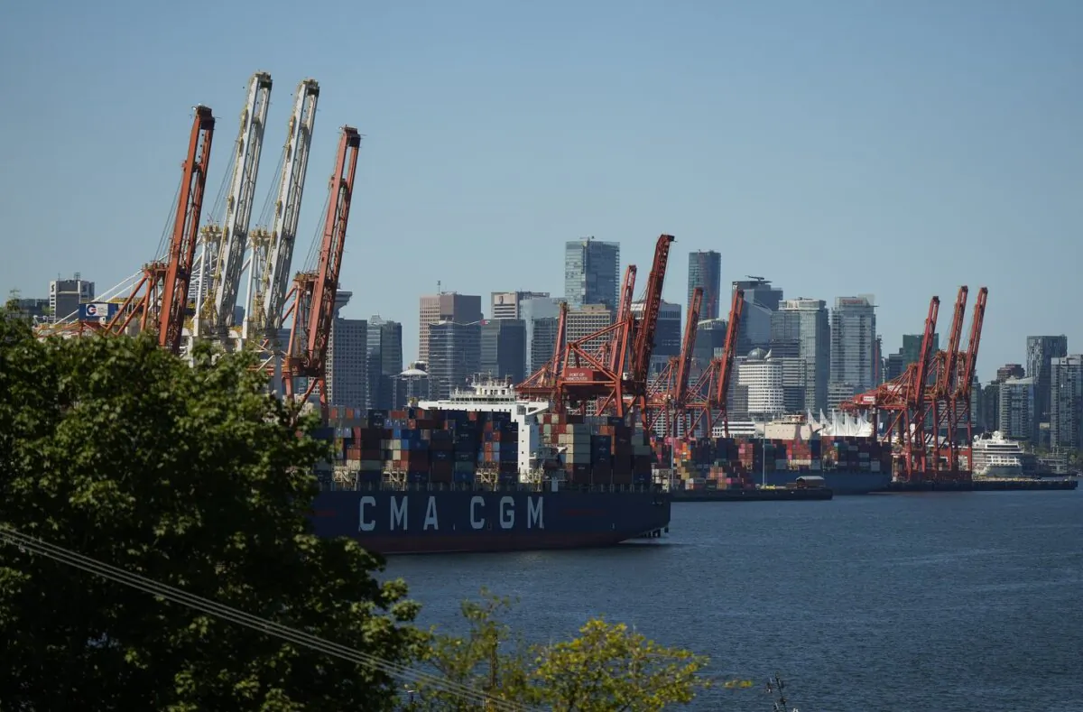 Gantry cranes sit idle as a container ship is docked at port in Vancouver, on July 19, 2023. (The Canadian Press/Darryl Dyck)