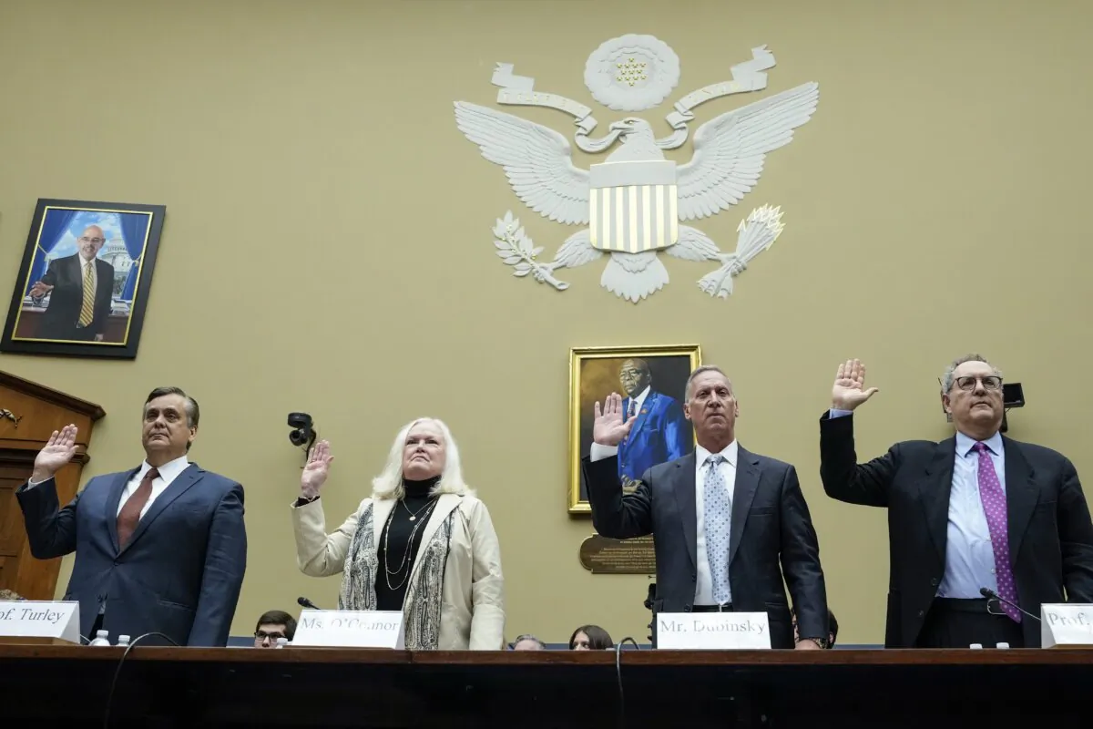 (L–R) George Washington law professor Jonathan Turley, former Assistant Attorney General Eileen O'Connor, Bruce Dubinsky, founder of Dubinsky Consulting, and North Carolina law professor Michael Gerhardt hold their hands up during their swearing in at a House Committee on Oversight and Accountability hearing on Capitol Hill in Washington on Sept. 28, 2023. (Mandel Ngan/AFP via Getty Images)