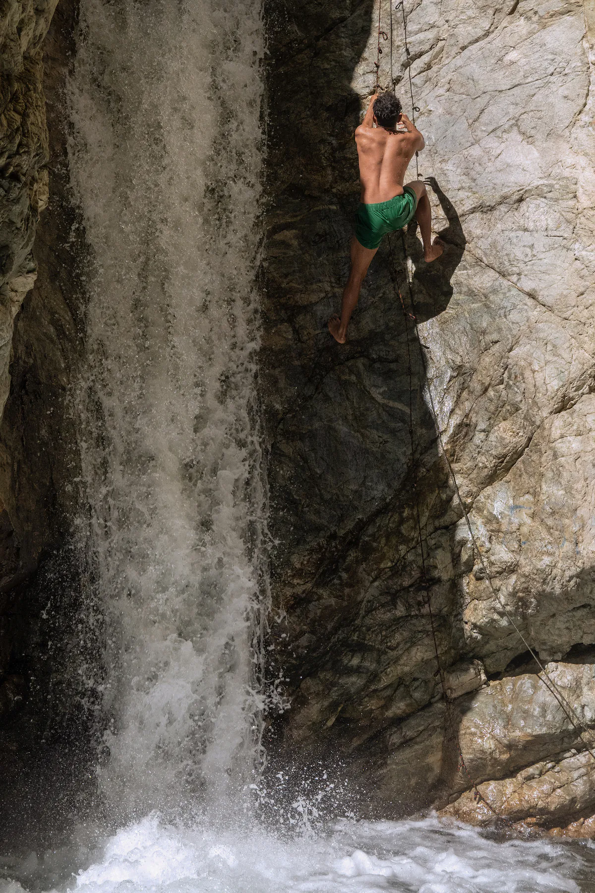 MT. BALDY, CA - SEPTEMBER 16: A visitor uses a rope to climb up a section of Stoddard Canyon Falls before jumping into the pool on Saturday, Sept. 16, 2023. (Myung J. Chun / Los Angeles Times)