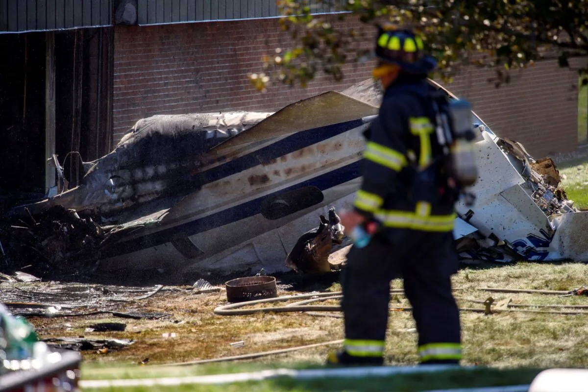 A firefighter near the wreckage of an aircraft that crashed into a building in Farmington, Conn., on Sept. 2, 2021. (Mark Mirko/Hartford Courant via AP)