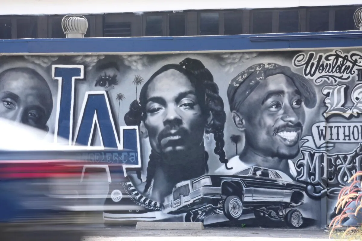 A portion of a mural by artist sloe_motions depicting Kobe Bryant, Snoop Dogg, and Tupac Shakur is seen on the side of Speedy Auto Tint, in Bellflower, Calif., on Sept. 29, 2023. (Chris Pizzello/AP Photo)
